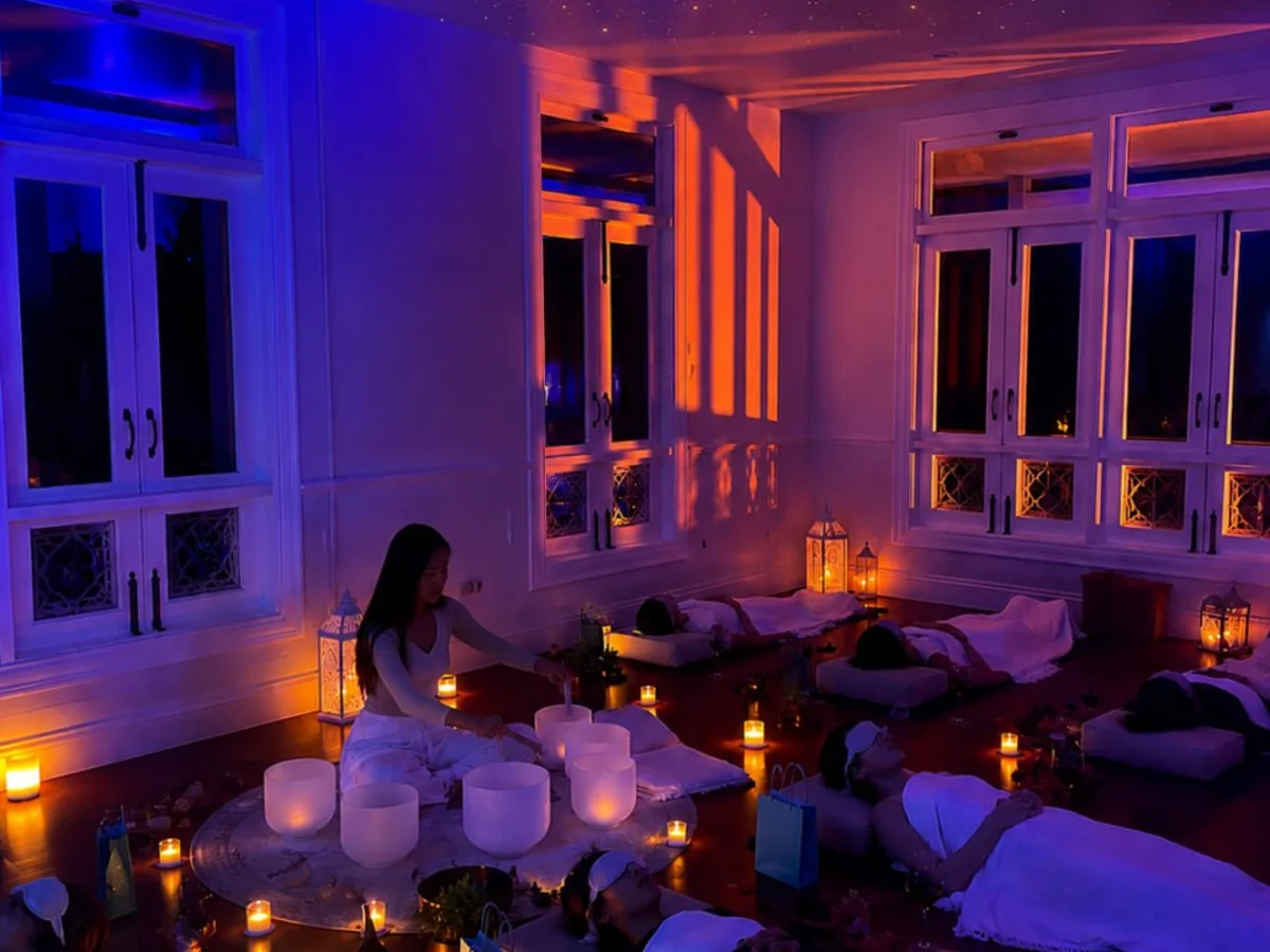 Candlelit night sound healing session beneath a starry ceiling